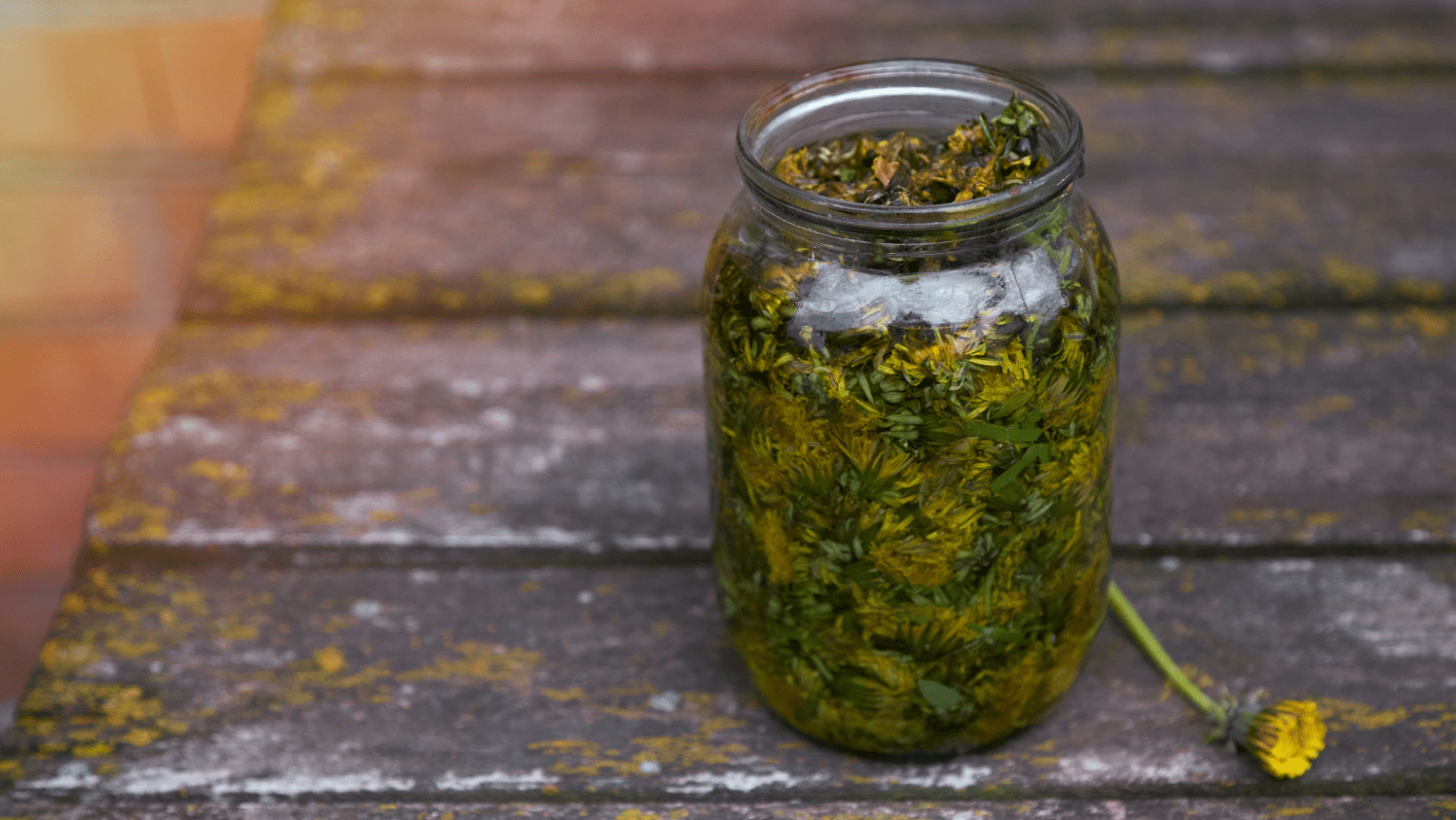 A jar of pickles sitting on top of a wooden table.