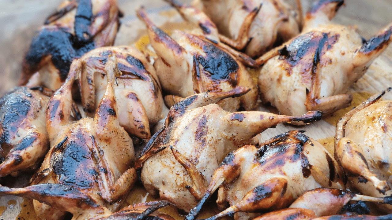 A close up of some chicken on the grill