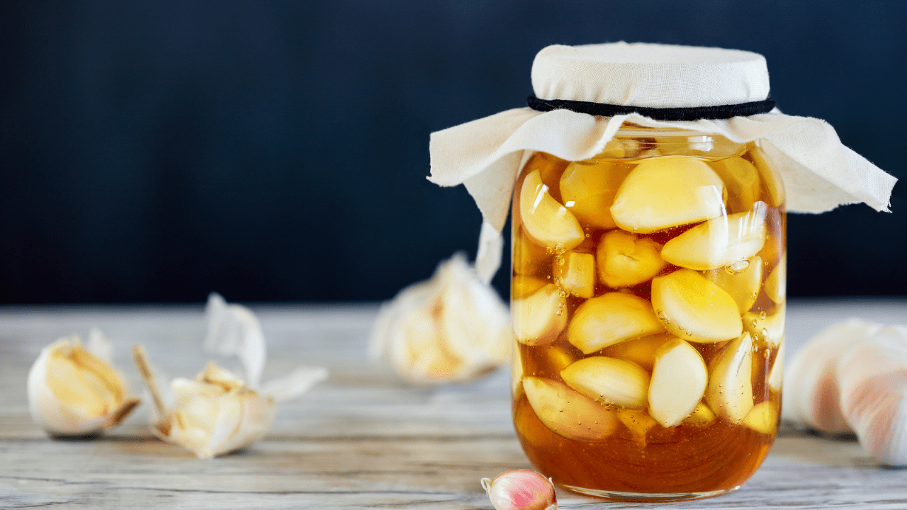 A jar of apples sitting on top of a table.