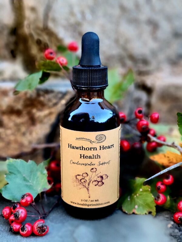 A bottle of hawthorn berry tincture sitting on top of some leaves.