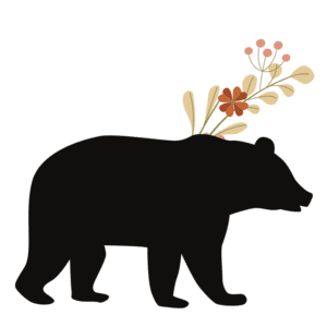 A bear with flowers in its hair is standing.