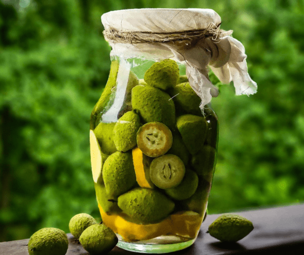 A jar of pickles on the table with some lemons